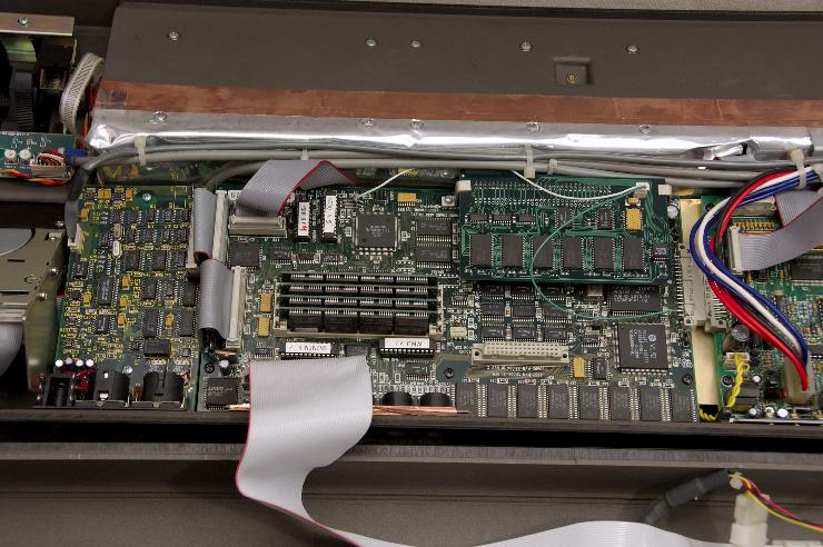 DSC_6954.jpg - Overall view of the secondary board with the PRAM option installed. Notice the white and green wires that must be soldered in order for the PRAM to work properly!The large flat gray ribbon cable is the SCSI connection to the internal hard drive, a Seagate Barracuda hot monster. It's been having issues with not spinning up completely, so it's time to replace it (or do the capacitor mod recommend on SonikMatter.com)!