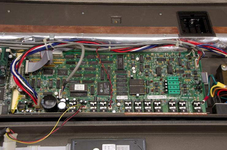 DSC_6955.jpg - Overall shot of the main board with the audio output connectorsWatch out for that monster capacitor!You can see the power leads (on the bottom left) for the hard drive and cooling fan